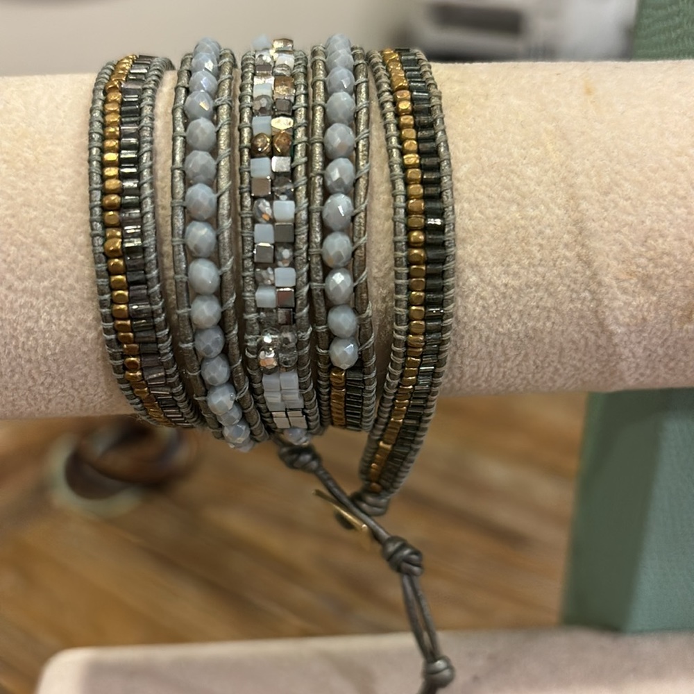 Wrap adjustable bracelet in blue/gray with gold tone accents and blue beads.